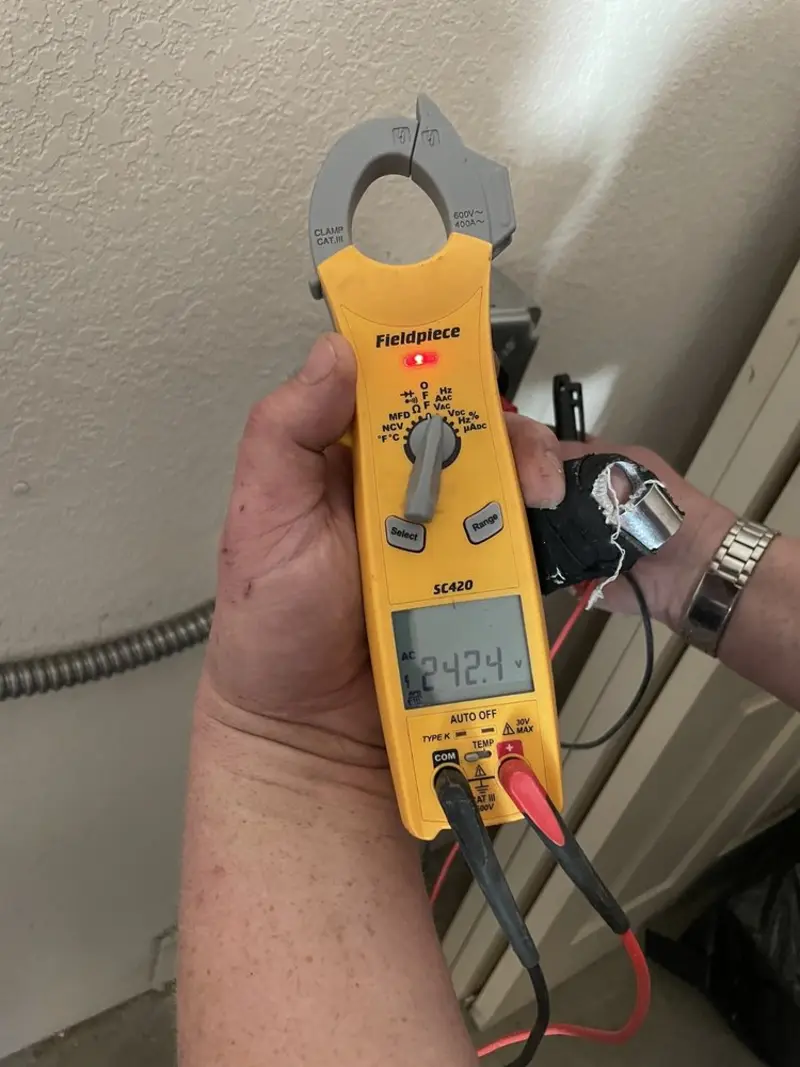 Voltage testing with clamp meter during Ceiling Fan Installation in Marlin